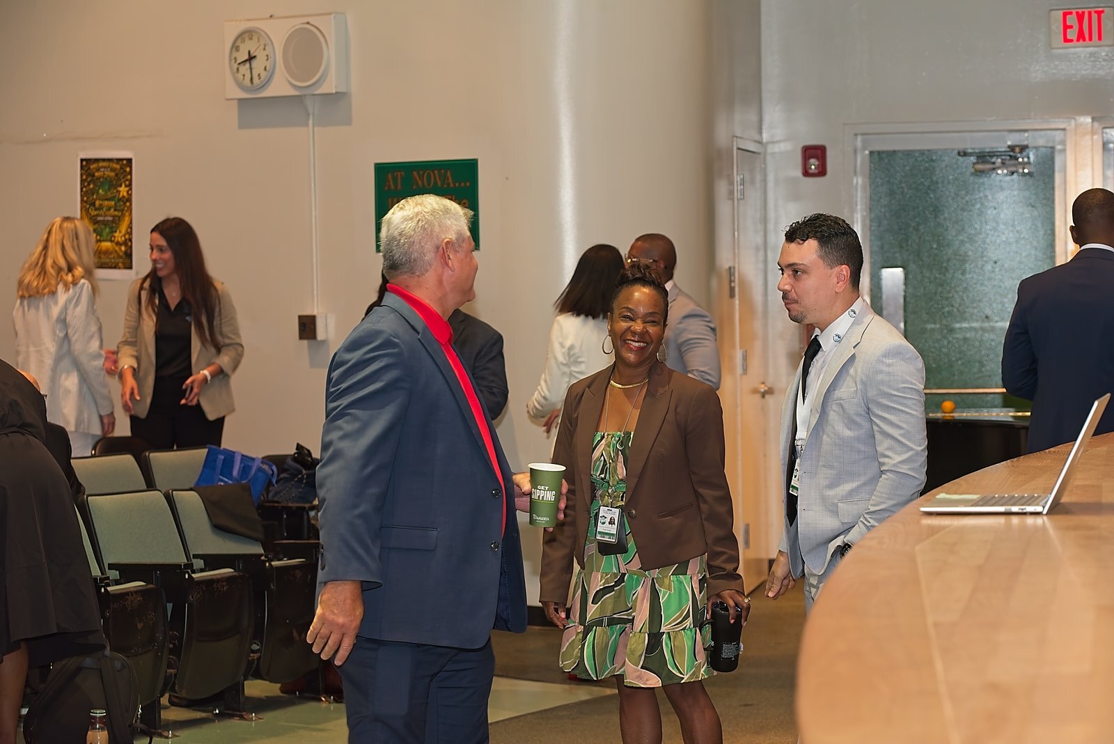 Leaders talking near the stage during a networking break