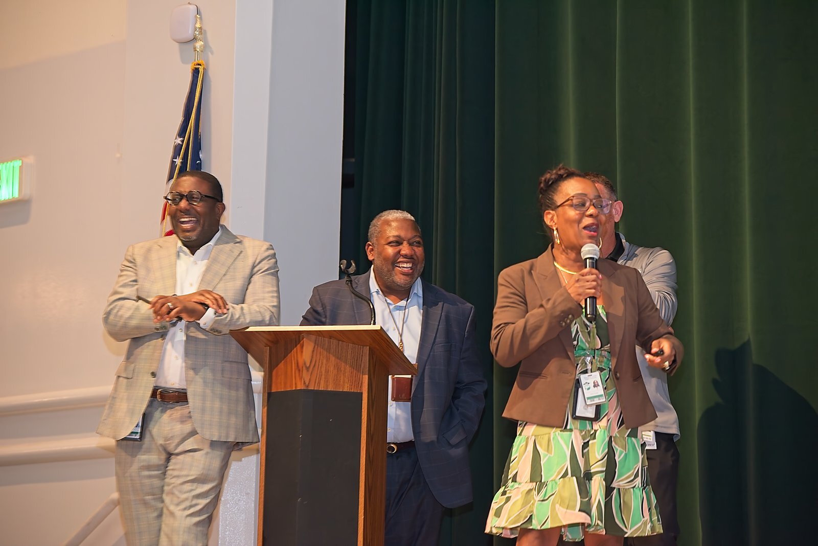 Leaders sharing a laugh together on stage
