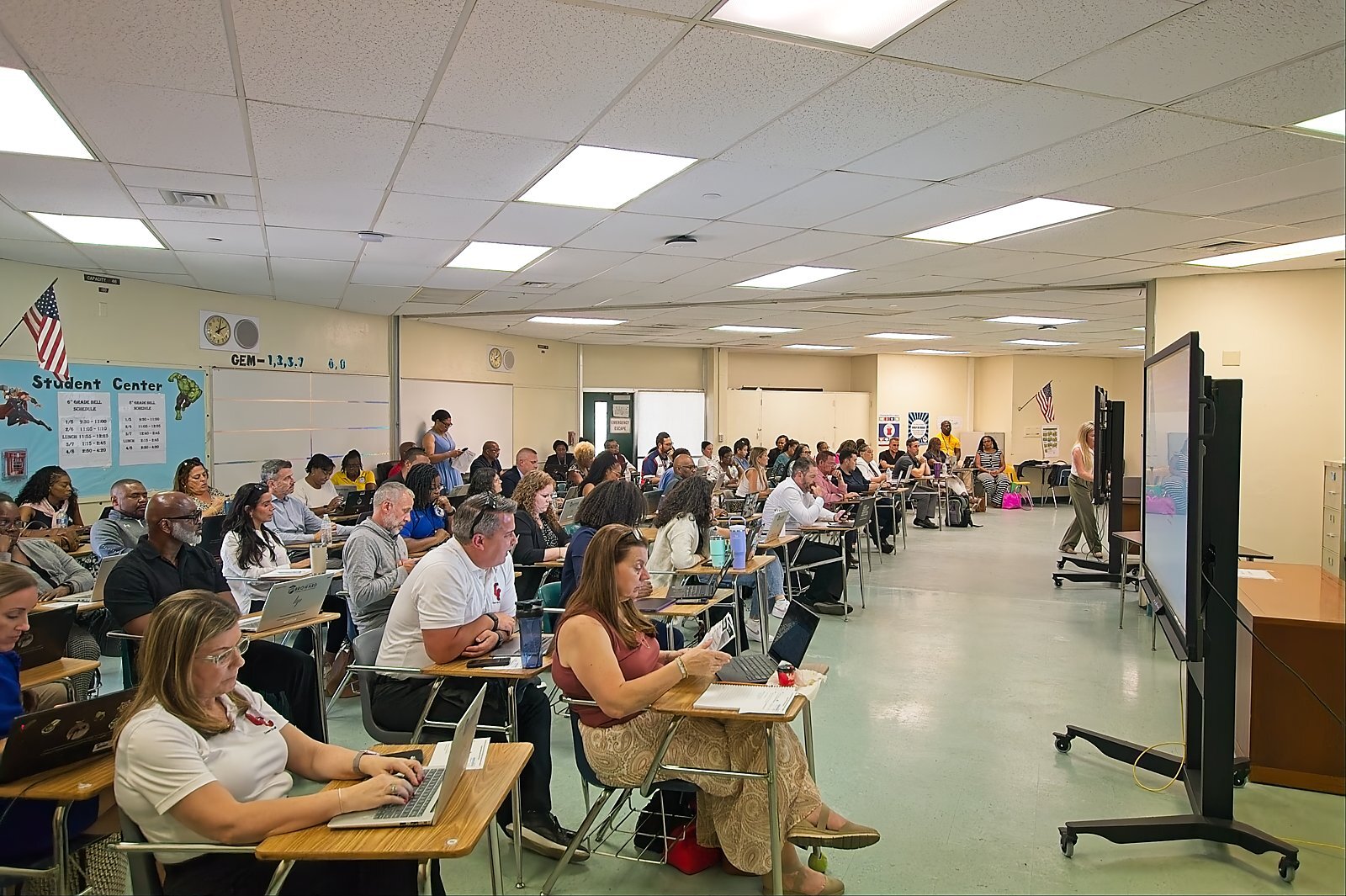 Attendees working on laptops during a breakout session classroom