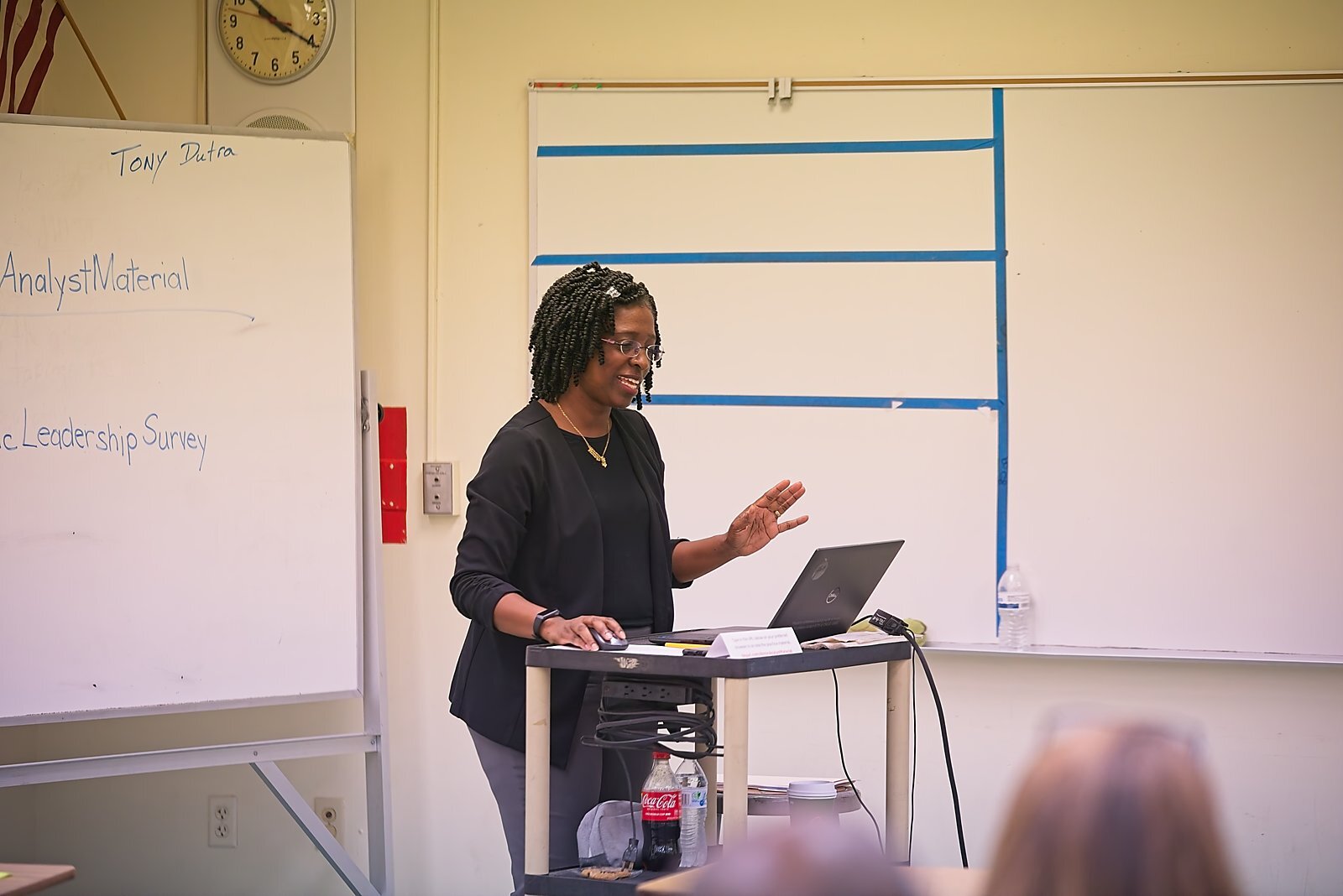 A presenter discussing survey and analyst material with attendees